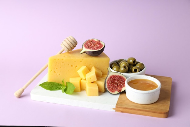 Concept of cooking eating with hard cheese on purple background