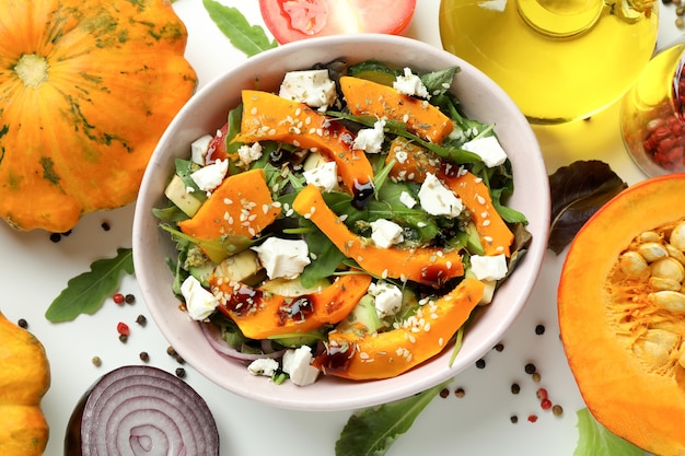 Concept of cooking pumpkin salad on white background