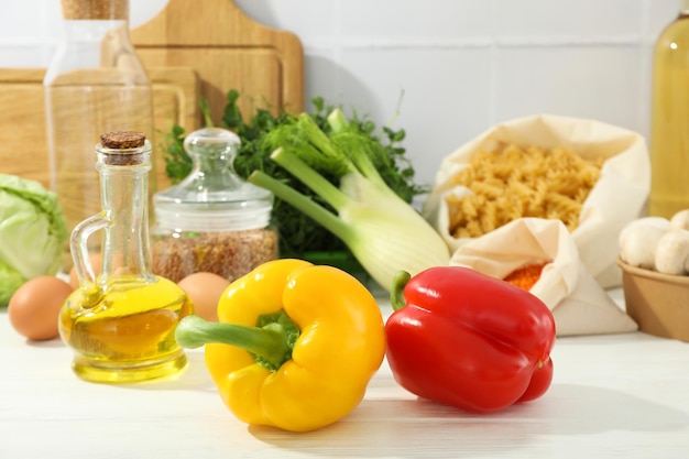 Concept of cooking with bell peppers on white wooden table