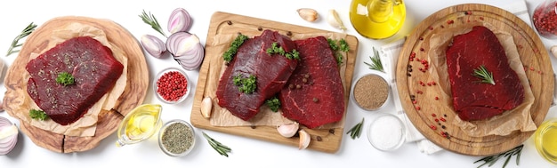 Concept of cooking with raw beef steaks on white background