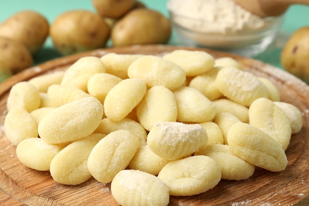 Concept of cooking with raw potato gnocchi, close up