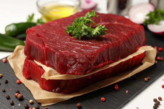 Concept of cooking with raw steak, close up