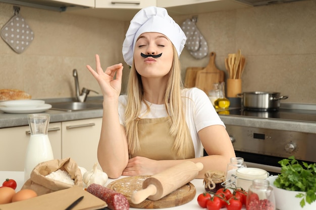 Concept of cooking with young attractive woman in kitchen room