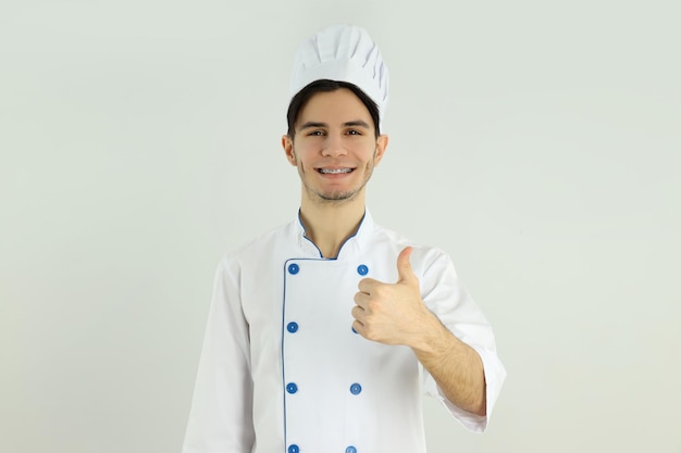 Concept of cooking young male chef on light background