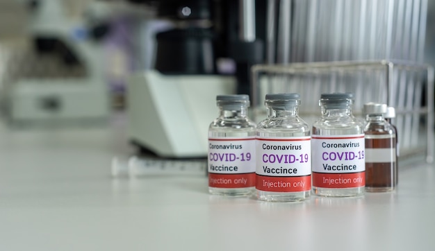 Concept of the coronavirus vaccine covid-19, in vitro. And a bottle of the vaccine against COVID-19 In medical science laboratories.