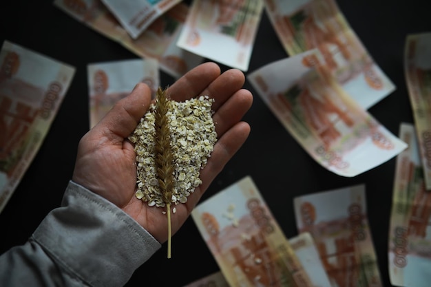 The concept of the cost of grain 5000 ruble banknotes around a handful of ground grain World hunger