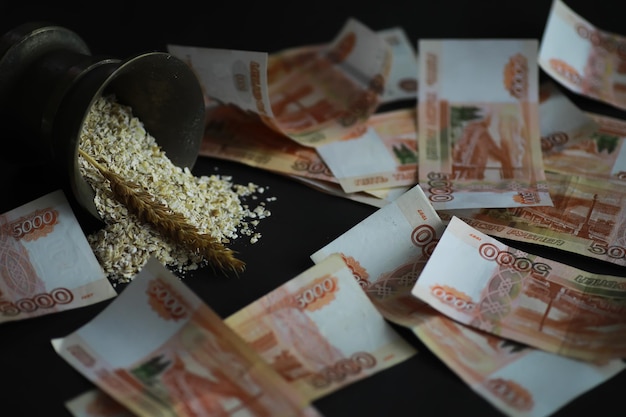 The concept of the cost of grain 5000 ruble banknotes around a handful of ground grain World hunger