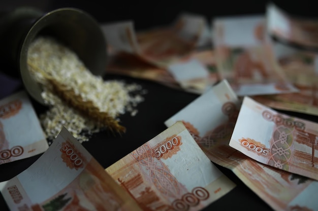 The concept of the cost of grain 5000 ruble banknotes around a handful of ground grain World hunger