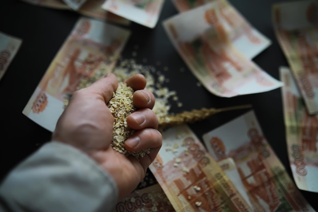 The concept of the cost of grain 5000 ruble banknotes around a handful of ground grain World hunger