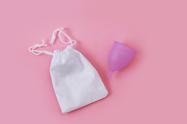 Concept of critical days menstruation Menstrual cup on pink background