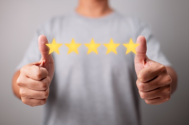 Photo concept of customer experience with a fivestar rating a happy client gives a thumbs up for great