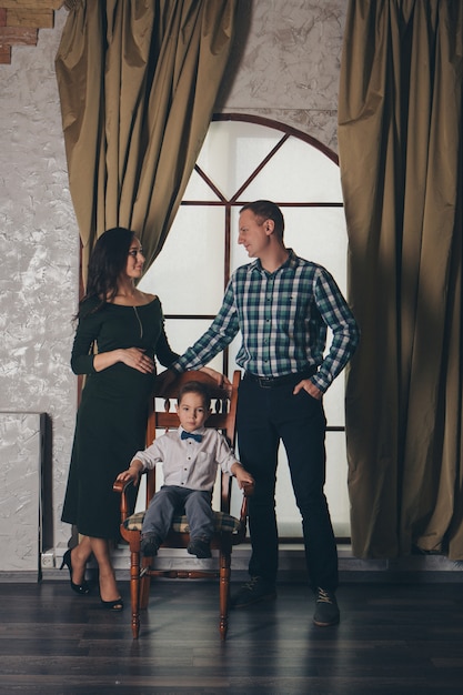 The concept of day rest, relaxation, thoughtfulness-family rests sitting on a chair. Calm expression of the people face, relaxed posture