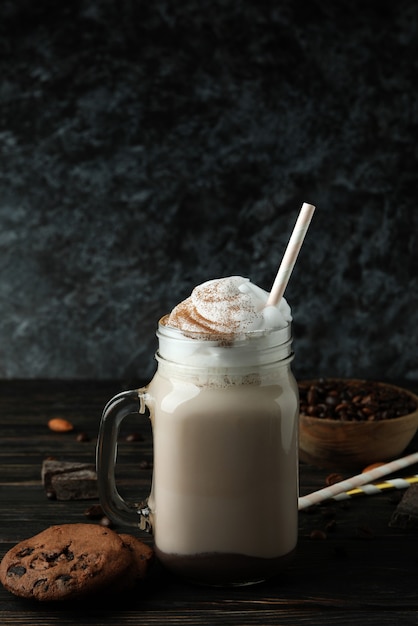 Concept of delicious food with chocolate milkshake on wooden table