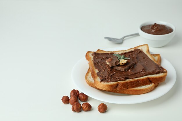 Concept of delicious food with chocolate paste on white background