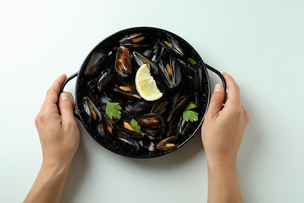 Concept of delicious food with mussels on white background