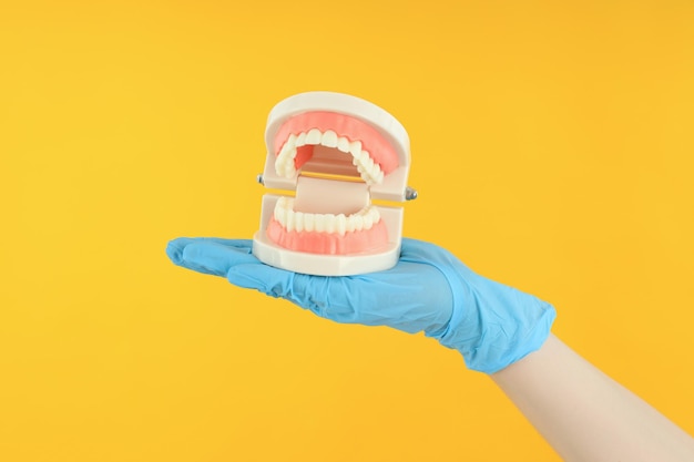 Concept of dental care on yellow background