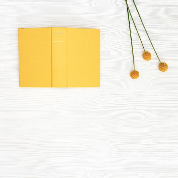 Concept digital detox offline home activities as reading book Top view with book in yellow cover