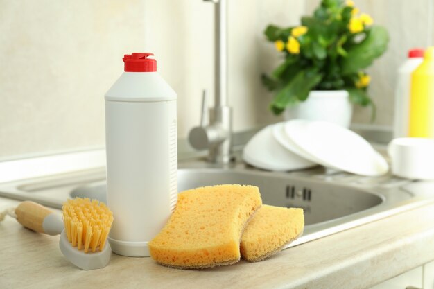 Concept of Dishwashing detergent accessories on kitchen background