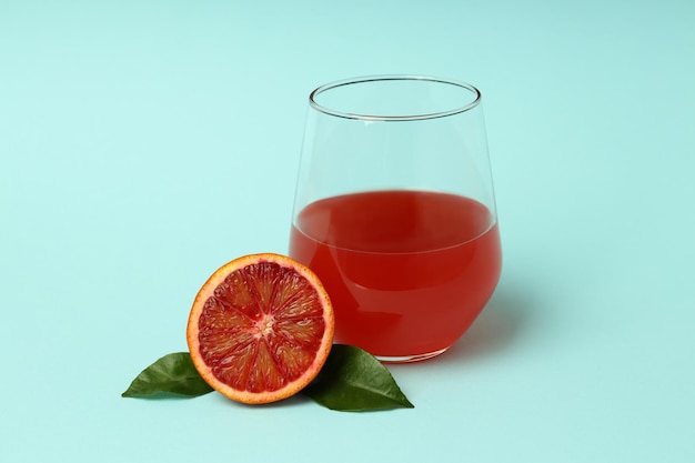 Concept of drink red orange juice on blue background