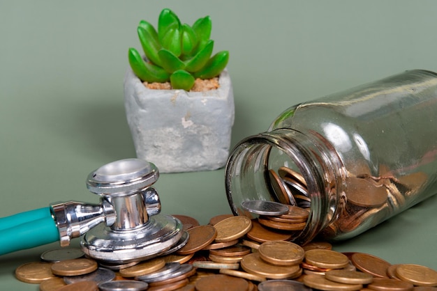 The concept of economy and medicine costs health Pile of real coins and stethoscope