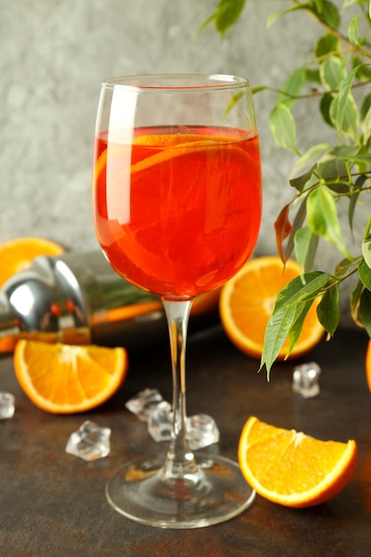 Concept of fresh alcohol drink Aperol Spritz on dark textured table