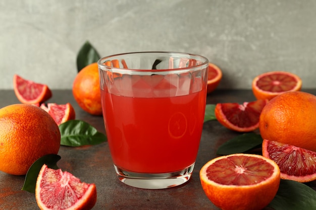 Concept of fresh drink with red orange juice close up