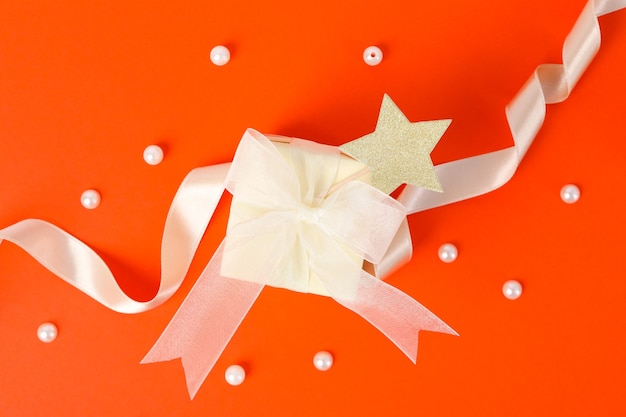 Concept of gift gift box on orange background