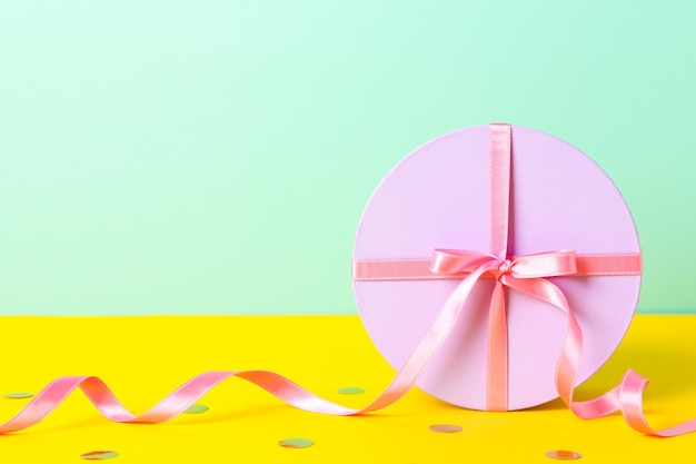 Concept of gift gift box on two tone background