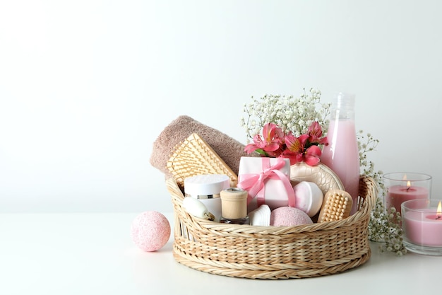 Concept of gift with basket of cosmetics on white table