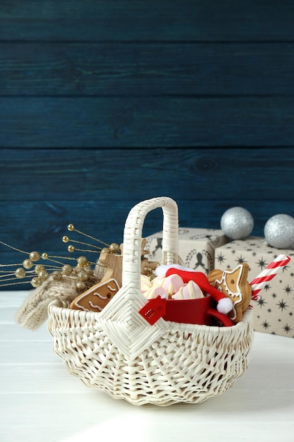 Concept of gift with Christmas basket on white wooden  table