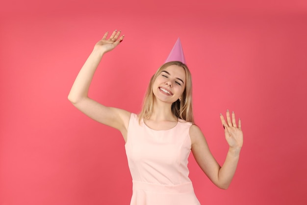 Concept of Happy Birthday with young woman on pink background