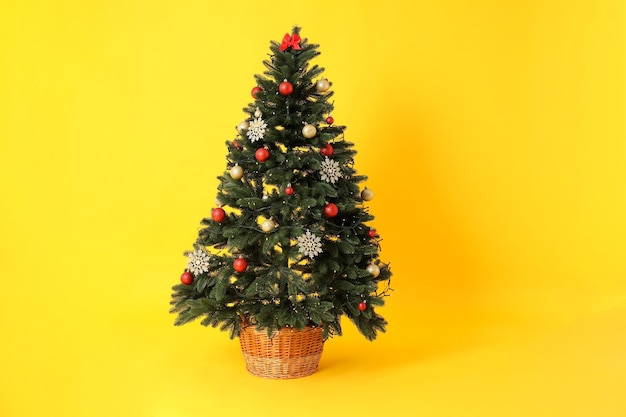 Concept of Happy New Year Christmas tree on yellow background