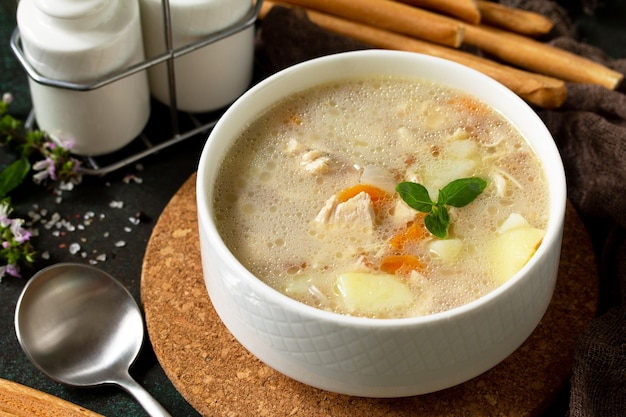 The concept of a healthy and diet food tasty soup with chicken cream cheese and cereals