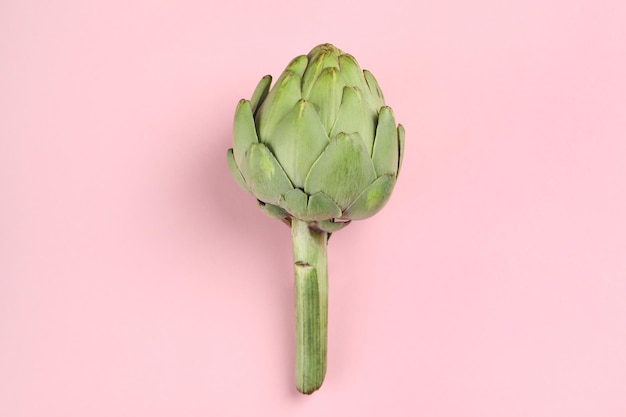 Concept of healthy food with artichoke on pink background