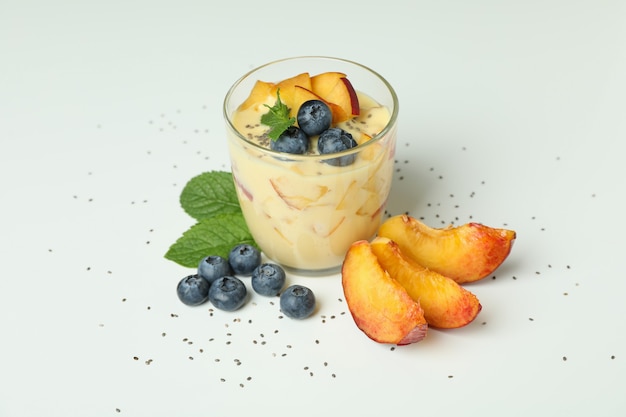 Concept of healthy food with peach yogurt on white background