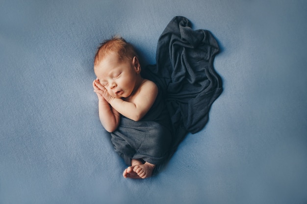 The concept of healthy lifestyle, IVF - a newborn baby sleeps under a blanket. Copy space