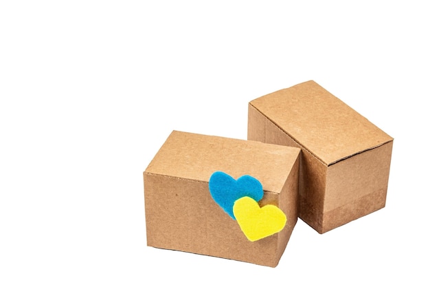 The concept of helping Ukraine in the war Boxes with hearts in the colors of the Ukrainian flag isolated on a white background