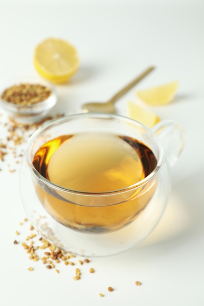 Concept of hot drink with buckwheat tea on white background