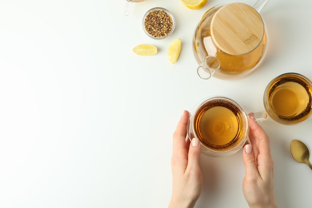 Concept of hot drink with buckwheat tea on white background