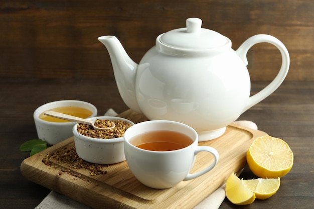 Concept of hot drink with buckwheat tea on wooden table