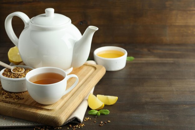 Concept of hot drink with buckwheat tea on wooden table