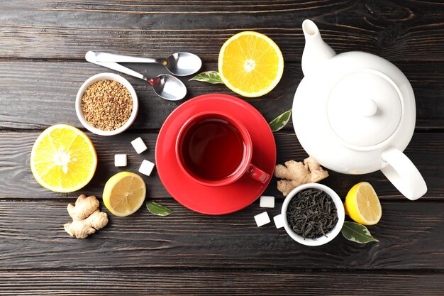 Concept of hot drink with tea on dark wooden background