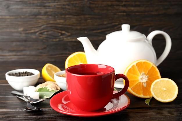 Concept of hot drink with tea on dark wooden table