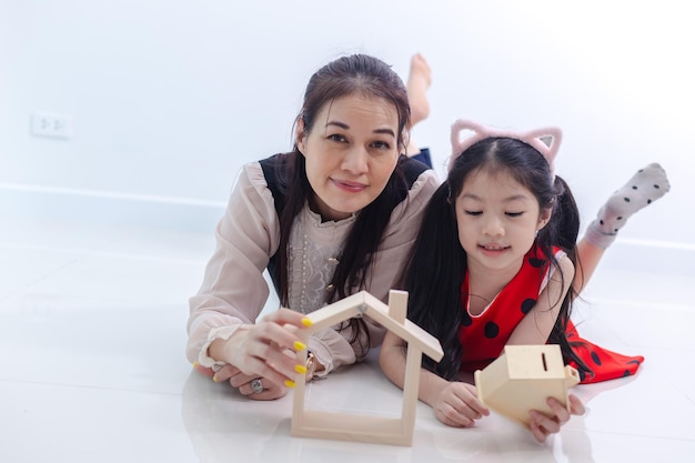 Concept housing family Mother and daughter with house model