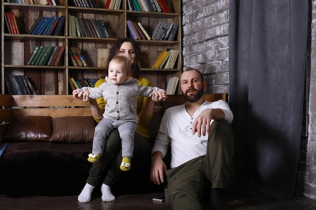 Concept of housing for young family. Parents playing with kids during family time at home.