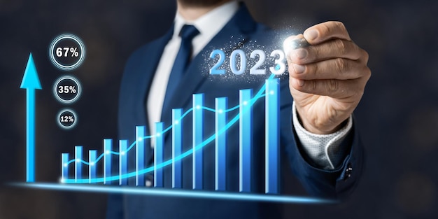 Concept of increase business in 2023 year businessman draws graph planning new strategy of growth goals and opportunities