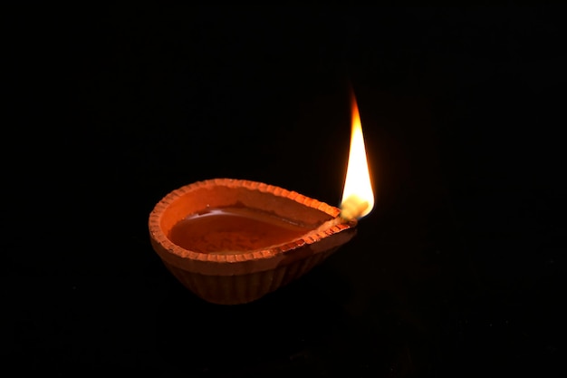 Concept of indian festival diwali Traditional oil lamps on dark background