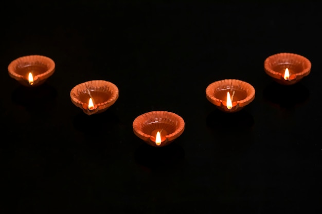 Concept of indian festival diwali Traditional oil lamps on dark background