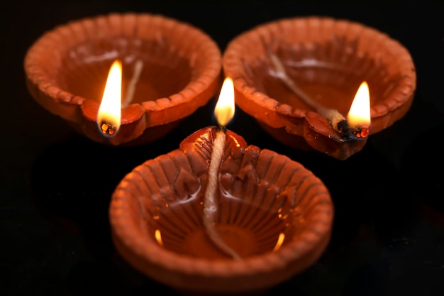 Concept of indian festival diwali Traditional oil lamps on dark background