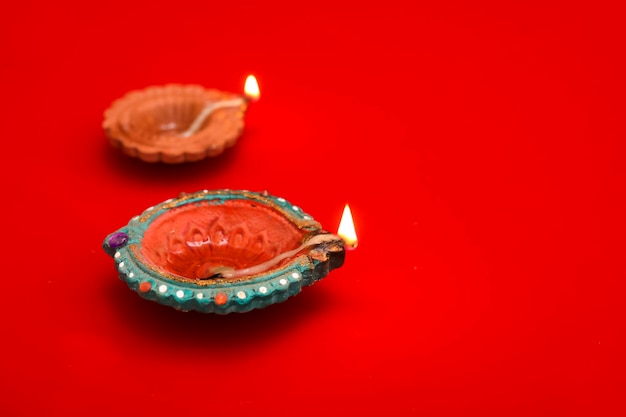 Concept of indian festival diwali Traditional oil lamps on Red background